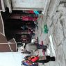 Tibetans prostrating in the courtyard before the entrance portico of the temple.