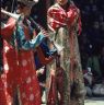 Monks: musician and incense burner holder during the procession around the dance arena, Paro Tshechu (tshe bcu).