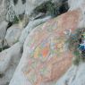 A painted rock carving of Green Tara.