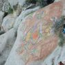 A painted rock carving of Green Tara.