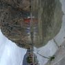 Painted carvings of bodhisattvas and Shakyamuni Buddha in a rock face.