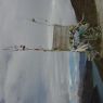 Prayer flags and a sign at the top of a pass.