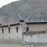 A Tibetan house with prayer flags on the roadside.