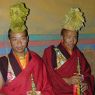 Two monk musicians dressed up with yellow hats (of the Geluk religious sect) and Tibetan clarinets (gyaling).