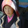 A young Tibetan woman visiting to watch the religious dance.