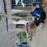 Tibetans sitting in front of a roadside restaurant.