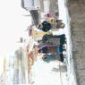 Pilgrims circumambulating a stupa at the monastery.