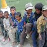 A group of young Tibetan boys visiting a famous temple.