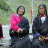 Tibetan pilgrims wearing black chubas and using rosaries at Zangdok Pelri Temple.