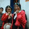 Young Tibetan man and Tibetan women with turquoise hair ornaments.