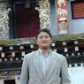 Tibetan man in front of Zangdok Pelri Temple.