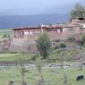 Tibetan houses made of earthen walls and logs.