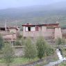 Tibetan house made of earthen walls and logs.