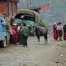 Tibetan monks and lay people at roadside.