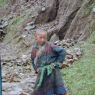 A Tibetan boy poses for the photographer on the side of the road.