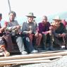 Seated Tibetan pilgrims with prayer wheels and rosaries at the Gyutrul Temple [sgyu 'phrul lha khang].