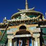 Ornate miniature gateway and small ceramic statues representing a mandala in the Gyutrul Temple [sgyu 'phrul lha khang].