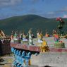 Ceramic statues of external deities on the perimeter of an upper level of the Gyutrul Temple representing a mandala of deities.