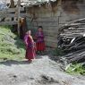 Two young monks outside a residence.