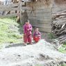 Two young monks outside a monastic residence.