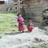 Two young monks outside a monastic residence.