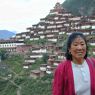 A Chinese woman with the monastery in the background.