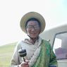 An elderly nomad spinning his prayer wheel.