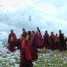 Monks offering paper prayer flags on top of one of the hills above Larung Gar.