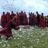 Monks offering paper prayer flags on top of one of the hills above Larung Gar.