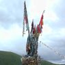 A close up of the hilltop cairn and prayer flags.