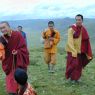 A Chinese monk, layman, and lamas near the cairn on top of Jomo Hill.