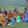 Chinese monks eating lunch on top of the hill.