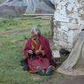 An elderly nun praying with her rosary.