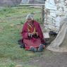 An elderly nun praying with her rosary.