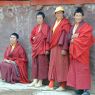 Nuns standing along a wall.