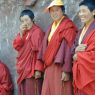 Nuns standing along a wall.