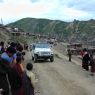 People bowing and greeting Khenpo Jikme Phutsok, the founder of the Larung Gar religious community, as he arrives in his car.