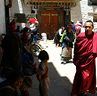 --Two monks walking outside Entrance of rMe ru monastery