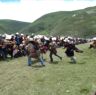 Tibetan men and women preparing to watch horse festival.