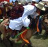 Tibetan man racing horse in Lhagang horse festival