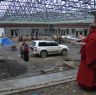 Monk examining new construction at Dora Garmo.