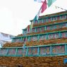 Painted carvings of buddhas framed in a pile of prayer stones. ??