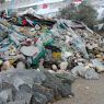 A pile of prayer flags, carved prayer stones, and yak skulls.