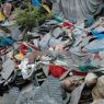 A pile of prayer flags, carved prayer stones, and yak skulls.