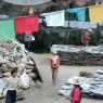 Pilgrims at the pile of prayer flags and prayer stones.