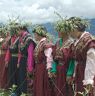 Ladies dressed in Shingka wearing chrysanthemum hats holding chrysanthemum plants