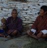 Old man turning handy prayer wheel to gain merit