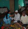 Woman applying tika to her brother