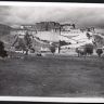 South face of Potala seen from distance with grassy foreground. Copyright Pitt Rivers Museum, University of Oxford 2001.35.110.1