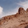 The rocky spine of the formation. The remains of the semi-subterranean dependencies and temple (lower right side) are visible on the slopes below the rocky spine.